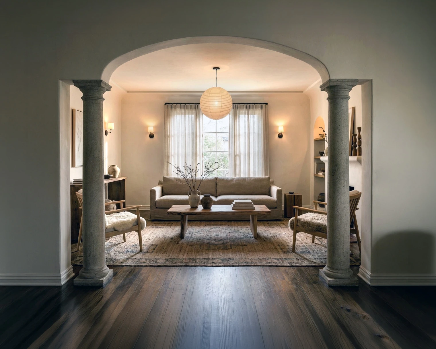 Smooth cream cast stone columns flanking an arched opening