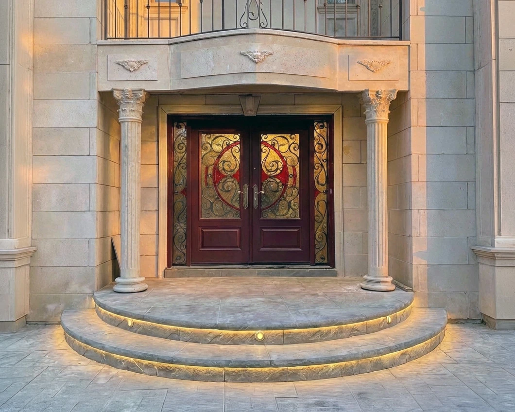 Ornate cast stone Corinthian columns flanking a grand entry