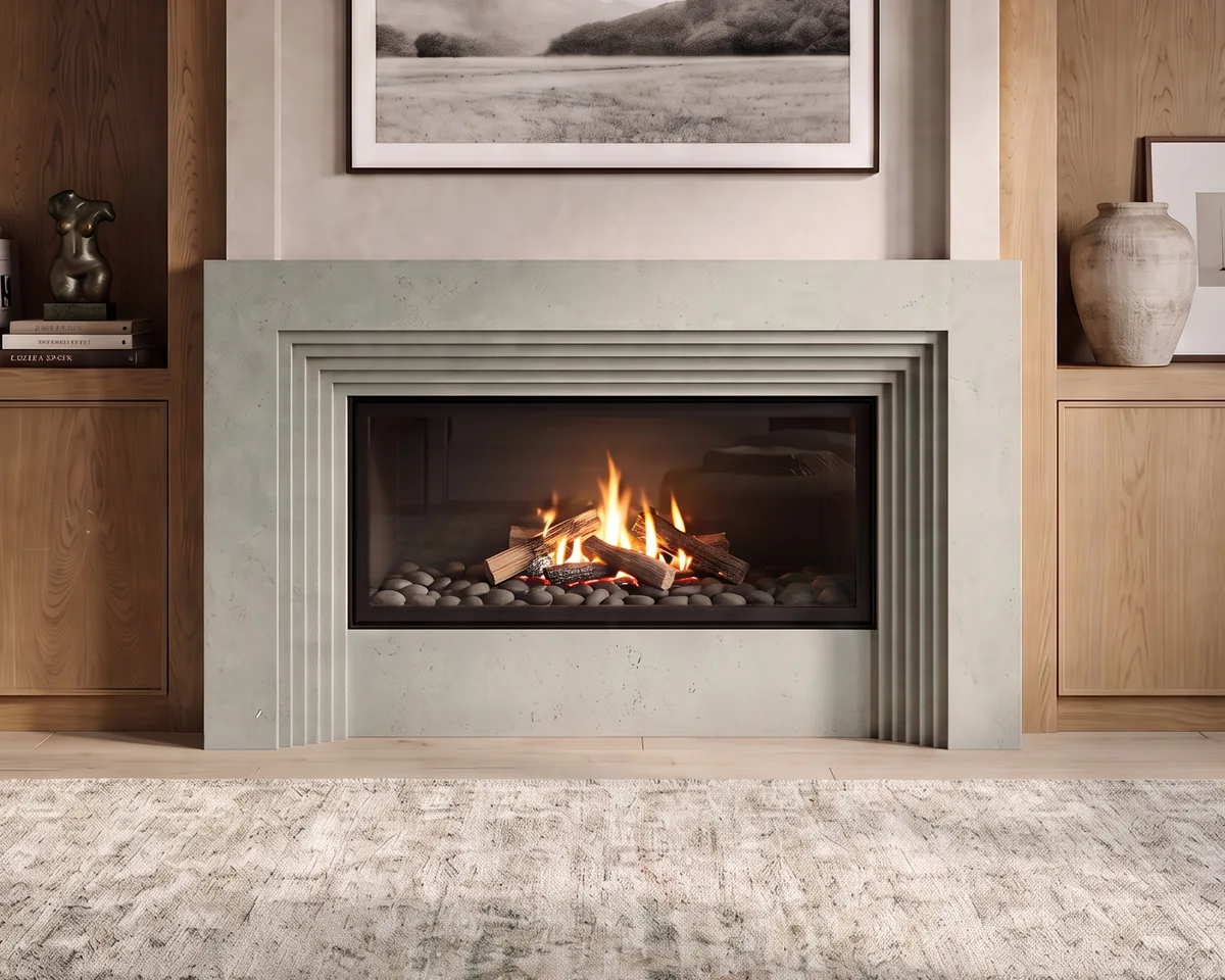 Lit fire in a stepped cast stone fireplace mantel between oak cabinetry